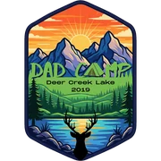 2019 Dad Camp patch: tall hexagon with a sunrise over mountains, pine forest, lake and a deer silhouette, reading Dad Camp, Deer Creek Lake 2019
